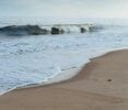 Waves rolling in on a sandy beach