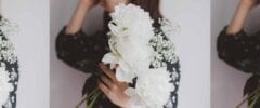 woman holding bouquet of white flowers