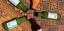 Organic_Krush-Juices laying on a carpet.
